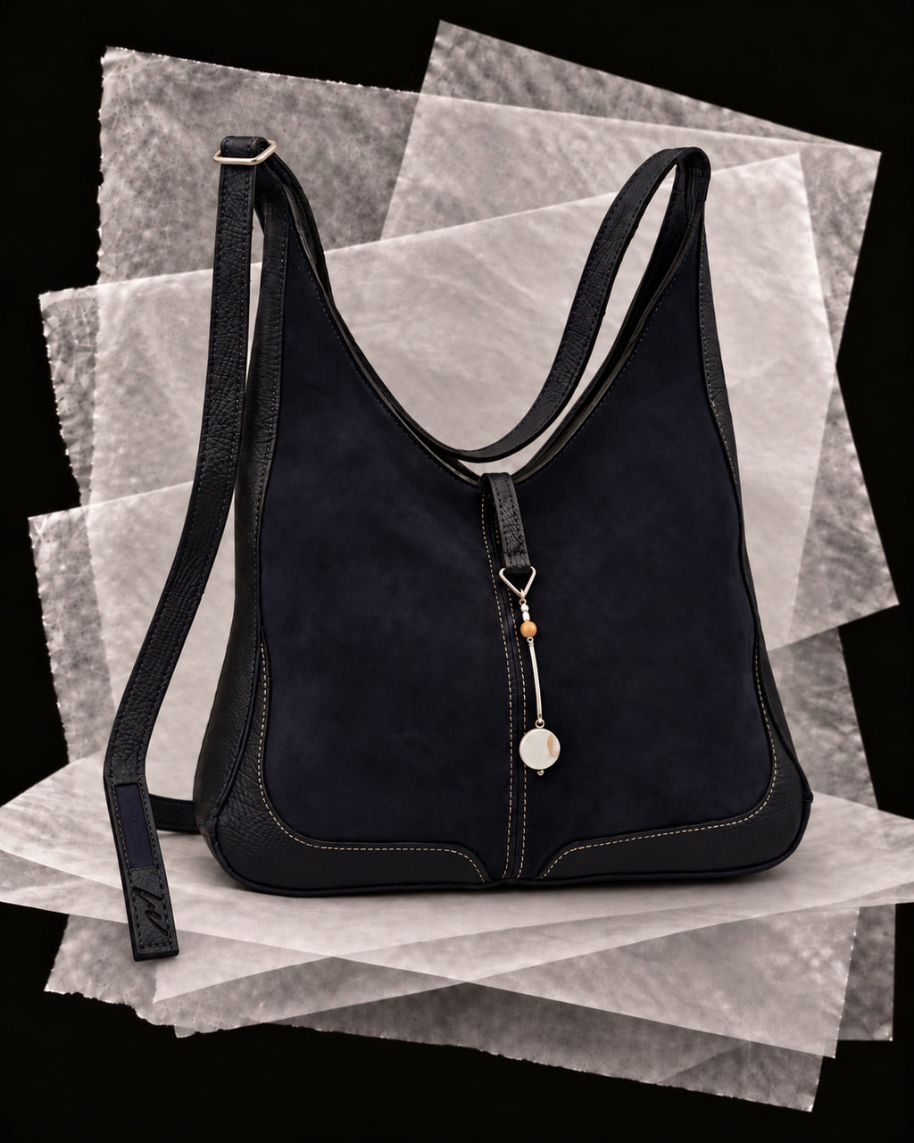 Andrea bag in Slate with the Perla amulet, a silver bar with a pearl disc and amber bead