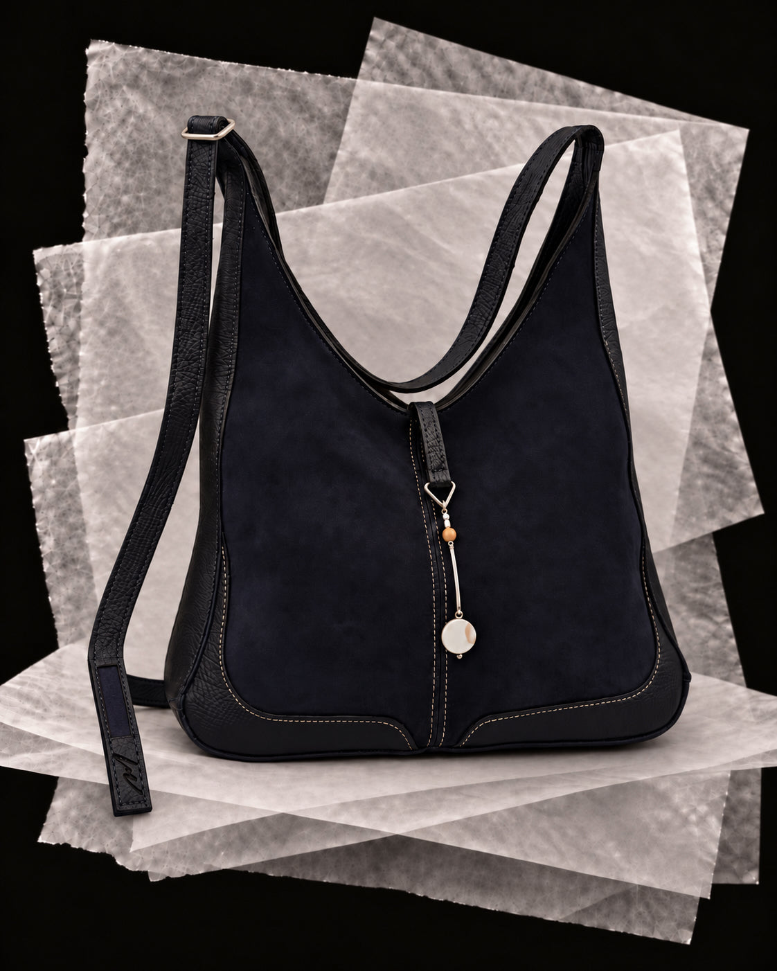 Andrea bag in Slate with the Perla amulet, a silver bar with a pearl disc and amber bead