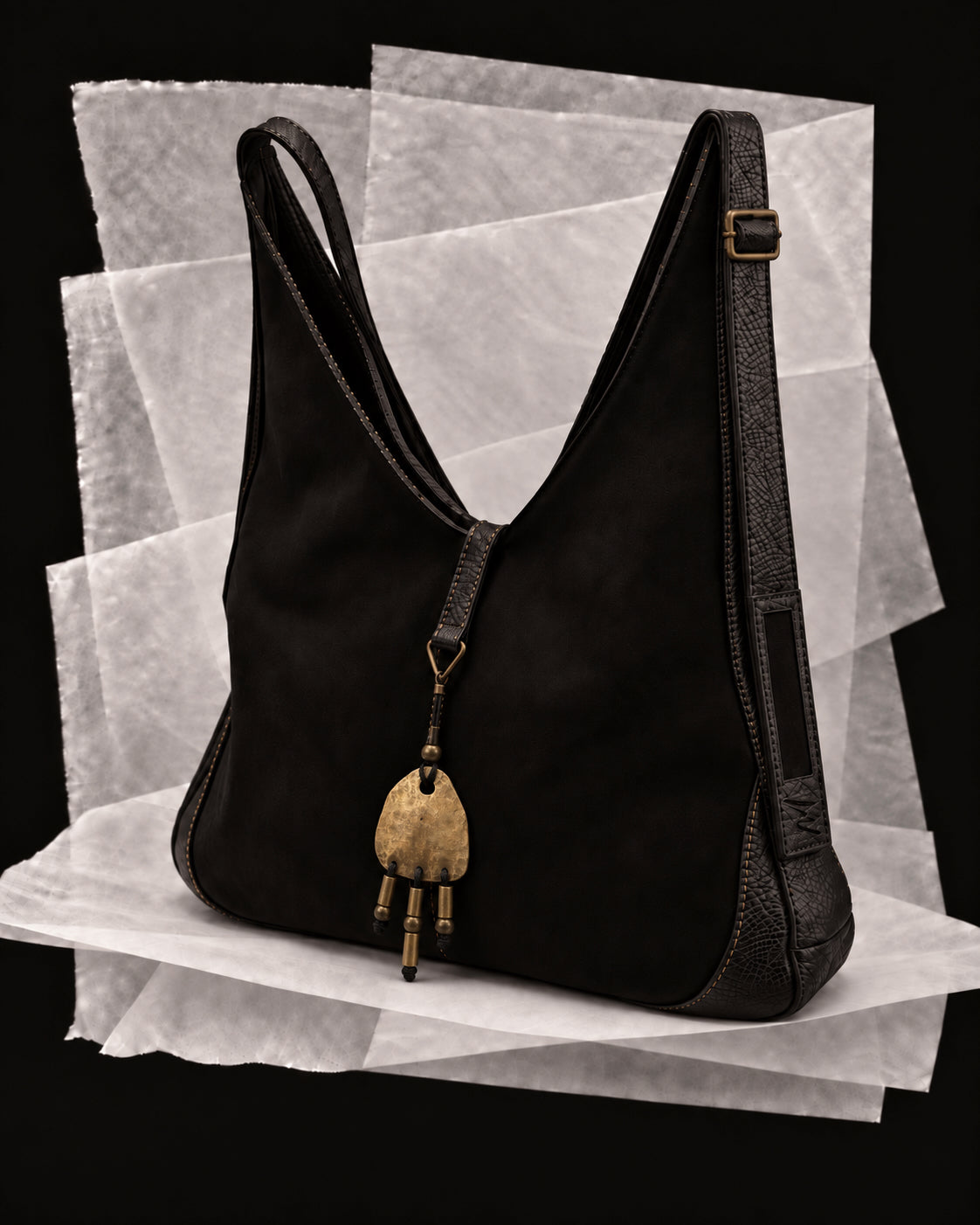 Andrea bag in Black with the Bronce amulet, a hand-finished bronze form with three suspended lines