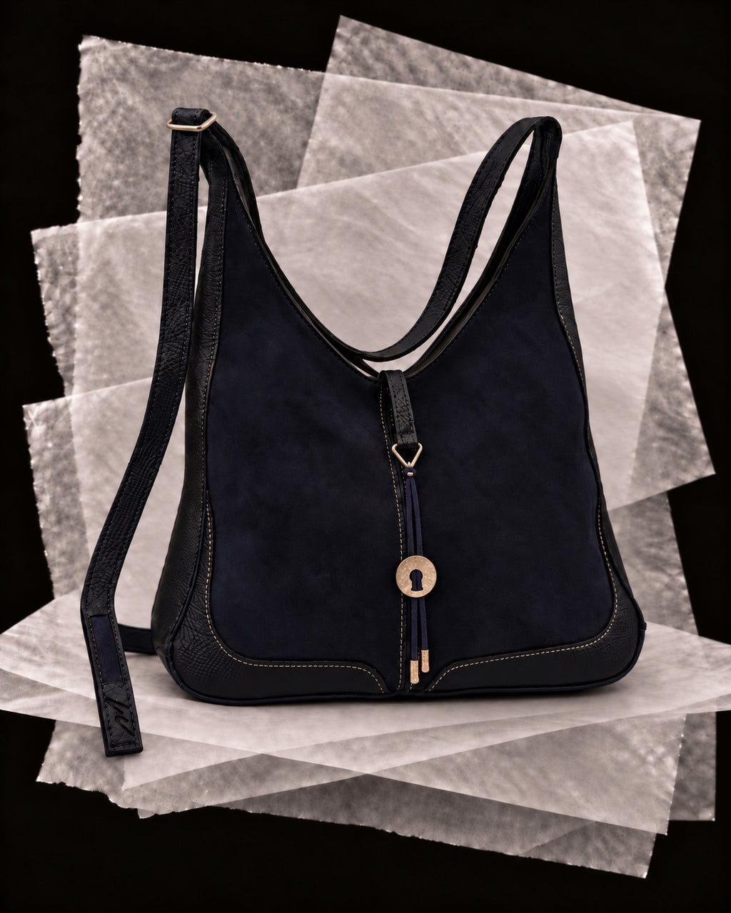 Andrea bag in Slate with the Plata amulet, a hammered silver disc on a slate leather cord
